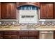 Stylish kitchen with dark wood cabinets, stainless steel appliances, and granite countertops at 4347 Westminster Pl, Columbus, IN 47201