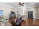 Elegant living room with hardwood floors, ceiling fan, and stylish furnishings at 4347 Westminster Pl, Columbus, IN 47201