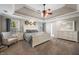 Spacious main bedroom featuring tray ceilings, a ceiling fan, and neutral carpeting at 4347 Westminster Pl, Columbus, IN 47201