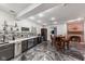Finished basement wet bar area with sleek cabinets, countertop, and dining space near fireplace at 4491 N 75 W, Franklin, IN 46184