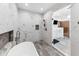 Spa-like bathroom featuring a soaking tub and a glass enclosed shower with white marble tile at 4491 N 75 W, Franklin, IN 46184