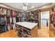 Large walk-in closet featuring custom storage solutions, an island and a view to the laundry at 4491 N 75 W, Franklin, IN 46184