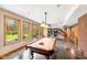 Spacious game room with pool table, pinball machines, and large windows overlooking backyard at 4491 N 75 W, Franklin, IN 46184