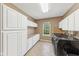 Bright laundry room with ample storage, granite countertops, and modern washer and dryer at 4491 N 75 W, Franklin, IN 46184