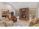 Cozy living room features a brick fireplace, comfortable seating, and hardwood floors at 4491 N 75 W, Franklin, IN 46184