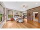 Bright main bedroom featuring hardwood floors, a brick accent wall, and plenty of natural light at 4491 N 75 W, Franklin, IN 46184