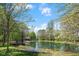 Scenic pond surrounded by trees with a small building in the background at 4491 N 75 W, Franklin, IN 46184
