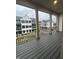 A covered balcony has black metal railings and a stained floor overlooking a neighboring community at 457 Mariposa Trl, Carmel, IN 46032