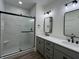 A primary bathroom features a marble-look tile shower, double sinks, and modern light fixtures at 457 Mariposa Trl, Carmel, IN 46032