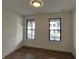 Bright bedroom with hardwood flooring, neutral walls, and black trimmed windows with neighborhood views at 457 Mariposa Trl, Carmel, IN 46032