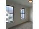Spacious bedroom with neutral walls, black trimmed windows with neighborhood views and plush carpeting at 457 Mariposa Trl, Carmel, IN 46032