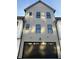 Stately three-story home featuring a dark gray garage door, light gray siding, and black trimmed windows at 457 Mariposa Trl, Carmel, IN 46032