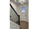 Welcoming foyer with hardwood floors, a staircase with black railings, and a front door with sidelight at 457 Mariposa Trl, Carmel, IN 46032
