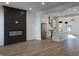 Spacious living room showcases a modern fireplace, open floor plan, hardwood floors, and stylish kitchen at 457 Mariposa Trl, Carmel, IN 46032