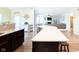 Spacious kitchen island with wooden cabinetry and an open view to the living room at 5852 Sunnyvalle Dr, Bargersville, IN 46106