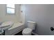 Cozy bathroom features a classic pedestal sink, toilet, and tub with shower fixtures at 611 Della Rd, Columbus, IN 47203