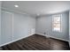Comfortable bedroom features recessed lighting, a window, wood-look floors, and neutral paint at 611 Della Rd, Columbus, IN 47203