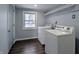 Laundry room with a large window and new washer and dryer at 611 Della Rd, Columbus, IN 47203
