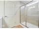 Well-lit bathroom showcases large shower with gray tile and glass door at 6724 Seattle Slew Dr, Whitestown, IN 46075