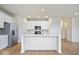 Modern kitchen featuring white cabinets, stainless steel appliances, and a large center island at 6724 Seattle Slew Dr, Whitestown, IN 46075