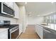 Modern kitchen with stainless steel appliances, white cabinets, and a large center island with sink at 6724 Seattle Slew Dr, Whitestown, IN 46075