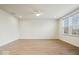 Bright, open living room with hardwood floors, a ceiling fan, and natural light at 6724 Seattle Slew Dr, Whitestown, IN 46075