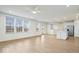 Spacious, open-concept living room and kitchen with hardwood floors and stainless steel appliances at 6724 Seattle Slew Dr, Whitestown, IN 46075