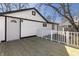 The exterior of the home features white siding, a backyard deck, and a white fence at 7252 E 47Th St, Indianapolis, IN 46226