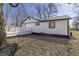 The exterior of the home features white siding and a backyard deck at 7252 E 47Th St, Indianapolis, IN 46226