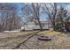 The exterior of the home features white siding, a backyard deck, and a fire pit at 7252 E 47Th St, Indianapolis, IN 46226