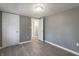 Bedroom features neutral grey walls, wood-look flooring, and two closet doors at 7252 E 47Th St, Indianapolis, IN 46226