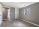 Bedroom featuring gray walls, wood-look floors, closet and natural light from window at 7252 E 47Th St, Indianapolis, IN 46226