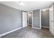 This bedroom features neutral grey walls, wood-look flooring, and two closet doors at 7252 E 47Th St, Indianapolis, IN 46226