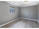 Bedroom with gray walls, laminate flooring, and natural light from a window at 7252 E 47Th St, Indianapolis, IN 46226