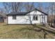 Charming home featuring white siding, black trim, and a well-maintained lawn at 7252 E 47Th St, Indianapolis, IN 46226