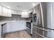Well-lit kitchen featuring white cabinets, modern appliances, and wood-look flooring at 7252 E 47Th St, Indianapolis, IN 46226