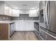 Updated kitchen with white cabinets, quartz countertops, and stainless steel appliances at 7252 E 47Th St, Indianapolis, IN 46226