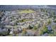 An aerial view shows this neighborhood is surrounded by mature trees and in close proximity to a school at 7943 Beaumont Green East Dr, Indianapolis, IN 46250