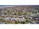 The aerial view shows houses on quiet, tree-lined streets with mature trees and neatly kept lawns at 7943 Beaumont Green East Dr, Indianapolis, IN 46250
