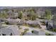 Stunning aerial view of a brick home with mature trees, lush landscaping, and a neighborhood basketball court at 7943 Beaumont Green East Dr, Indianapolis, IN 46250