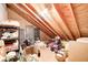 A storage attic showing exposed beams and plywood flooring with a variety of items stored inside at 7943 Beaumont Green East Dr, Indianapolis, IN 46250