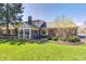 Expansive backyard featuring a sunroom and brick patio, perfect for outdoor entertaining and relaxation at 7943 Beaumont Green East Dr, Indianapolis, IN 46250