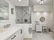 Bathroom with a bright vanity with marble counters and a glass enclosed shower with decorative tile surround at 7943 Beaumont Green East Dr, Indianapolis, IN 46250
