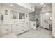 Bright bathroom with double vanity, white cabinets, marble floors, and glass enclosed shower at 7943 Beaumont Green East Dr, Indianapolis, IN 46250