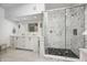 Modern bathroom features a glass shower with a decorative tile surround and double vanity with marble countertops at 7943 Beaumont Green East Dr, Indianapolis, IN 46250