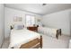 Bright bedroom with two twin beds, neutral walls, and a decorative side table under a window at 7943 Beaumont Green East Dr, Indianapolis, IN 46250