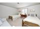 A bright bedroom featuring two twin beds, a side table, and a large window at 7943 Beaumont Green East Dr, Indianapolis, IN 46250