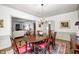 Elegant dining room features hardwood floors, chandelier, and connection to living room at 7943 Beaumont Green East Dr, Indianapolis, IN 46250
