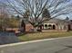 Charming brick home with a manicured lawn and mature trees adding curb appeal at 7943 Beaumont Green East Dr, Indianapolis, IN 46250