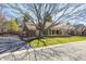 Well-maintained brick home with mature trees and landscaping, showcasing classic curb appeal and charm at 7943 Beaumont Green East Dr, Indianapolis, IN 46250